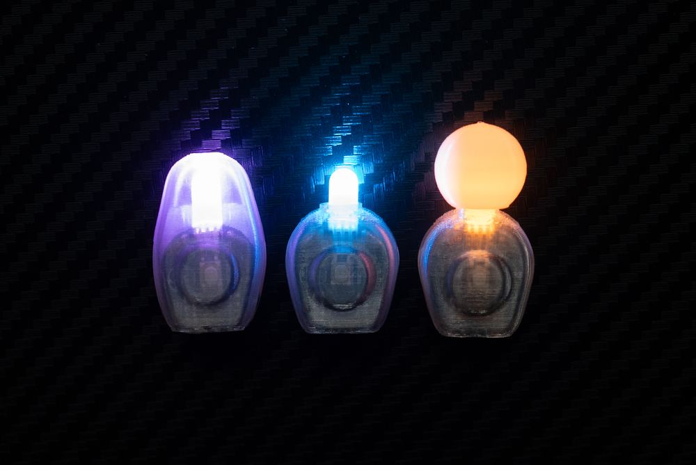 Three Glowskinz side by side showing the CLOZD casing, a bare OPYN casing, and an OPYN casing with a diffuser stacked on top